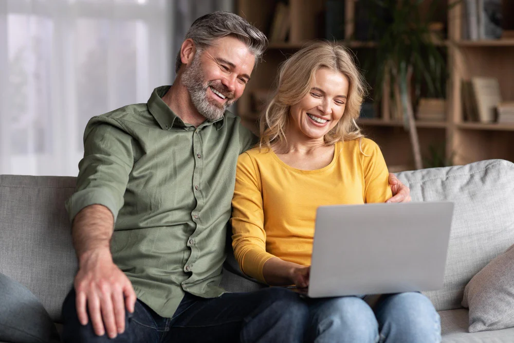 online-pastime-smiling-middle-aged-spouses-using-laptop-home-together-1024x683